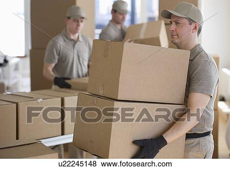 Men sorting boxes in warehouse View Large Photo Image Stock Photo - Men sorting boxes in warehouse. Fotosearch