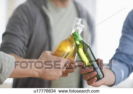 Picture - Men toasting with beer. Fotosearch