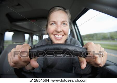 Mid adult woman driving View Large Photo Image Picture - Mid adult woman driving. Fotosearch