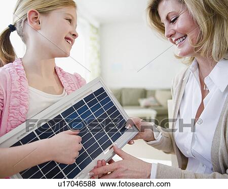 Mother and daughter (8-9) examining solar panel View Large Photo Image Stock Photo - Mother and daughter (8-9) examining solar panel. Fotosearch