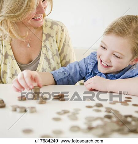 Mother and daughter (8-9) playing with coins View Large Photo Image Stock Photo - Mother and daughter (8-9) playing with coins. Fotosearch
