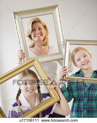 Mother and daughters (8-11) holding picture frames View Large Photo Image Stock Image - Mother and daughters (8-11) holding picture frames. Fotosearch