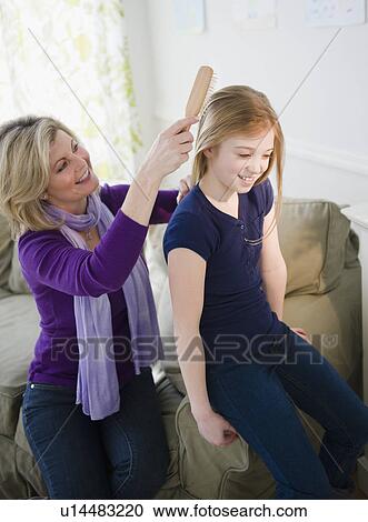 Mother brushing daughter's (10-11) hair View Large Photo Image Stock Image - Mother brushing daughter's (10-11) hair. Fotosearch
