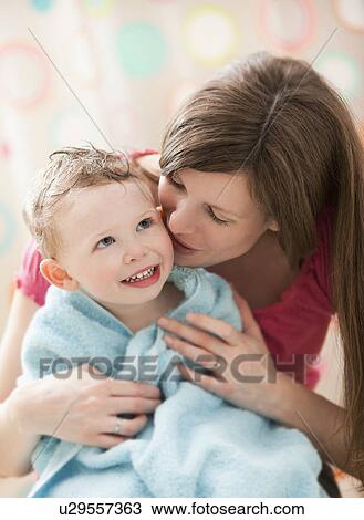 Stock Image - Mother with son (2-3) wrapped in towel. Fotosearch