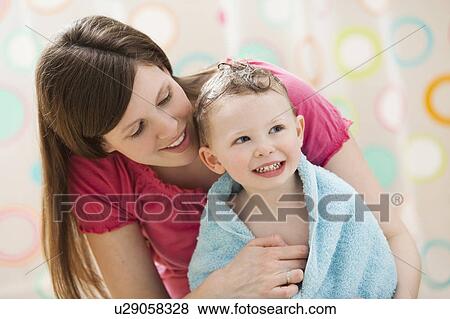 Stock Photo - Mother with son (2-3) wrapped in towel. Fotosearch