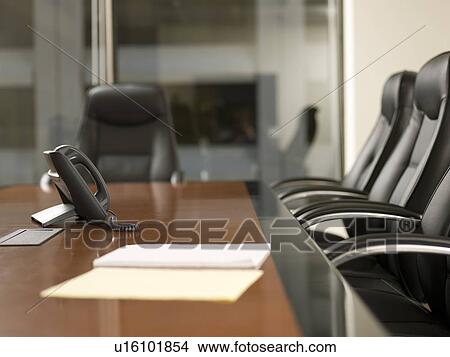 Picture - Paper and telephone in board room. Fotosearch