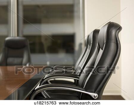 Stock Image - Paper and telephone in board room. Fotosearch