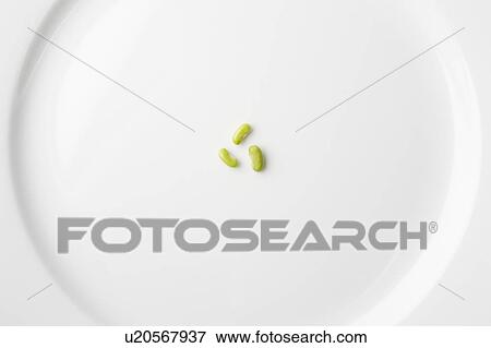 Peas on white plate forming recycling symbol View Large Photo Image Stock Photo - Peas on white plate forming recycling symbol. Fotosearch