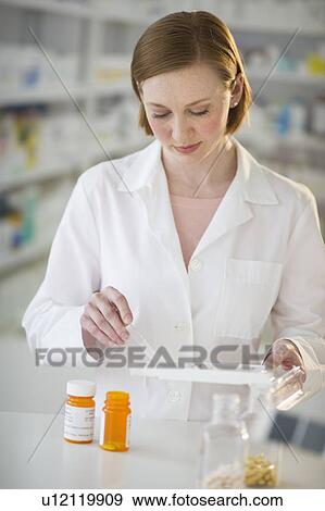 Stock Photo - Pharmacist preparing medicine. Fotosearch