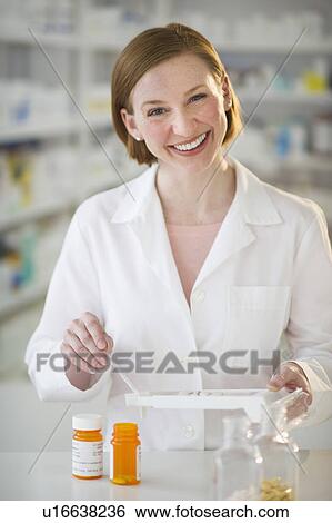 Stock Photograph - Pharmacist preparing medicine. Fotosearch