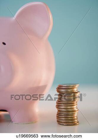 Stock Image - Piggy bank and stack of coins. Fotosearch