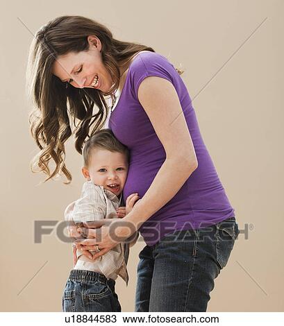 Portrait of boy (2-3) leaning on pregnant mother's belly View Large Photo Image Stock Image - Portrait of boy (2-3) leaning on pregnant mother's belly. Fotosearch