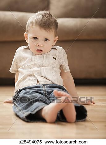 Portrait of boy (2-3) sitting on floor View Large Photo Image Stock Photography - Portrait of boy (2-3) sitting on floor. Fotosearch