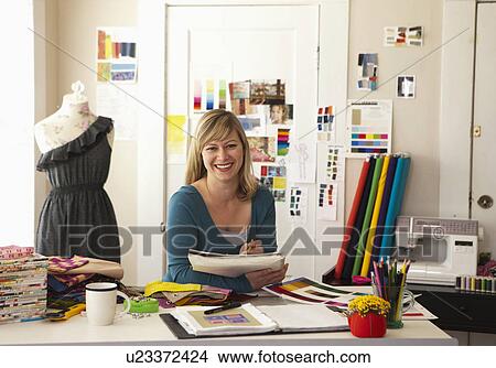 Picture - Portrait of female fashion designer working in studio. Fotosearch