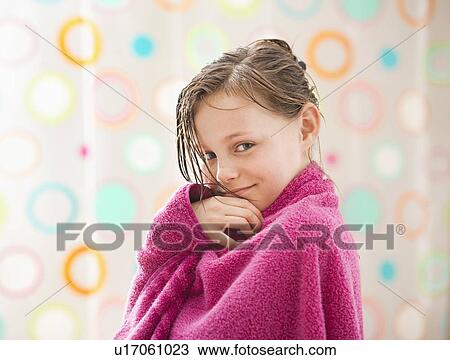 Stock Image - Portrait of girl (10-11) wrapped in towel. Fotosearch