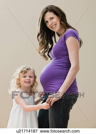 Portrait of girl (2-3) and pregnant mother View Large Photo Image Stock Photo - Portrait of girl (2-3) and pregnant mother . Fotosearch