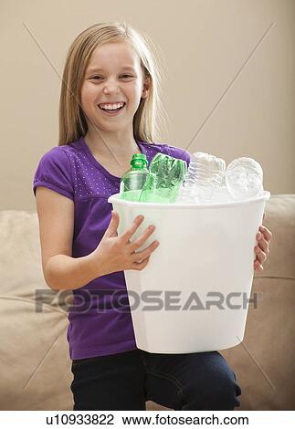 Portrait of girl (8-9) holding recycling bin with plastic bottles View Large Photo Image Stock Image - Portrait of girl (8-9) holding recycling bin with plastic bottles. Fotosearch