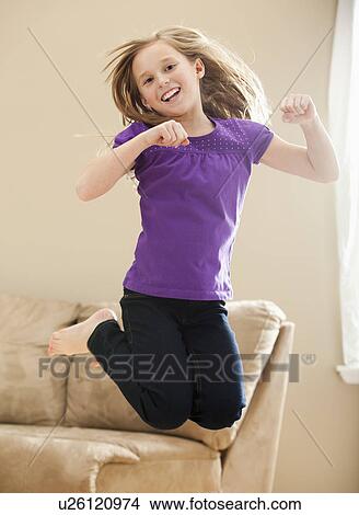 Picture - Portrait of girl (8-9) jumping. Fotosearch