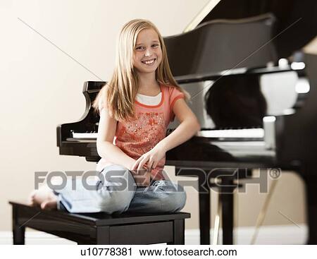 Portrait of girl (8-9) sitting by piano View Large Photo Image Stock Image - Portrait of girl (8-9) sitting by piano. Fotosearch