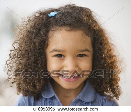 Stock Photography - Portrait of smiling girl (6-7) with afro. Fotosearch