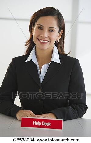 Picture - Portrait of smiling woman at customer service desk. Fotosearch