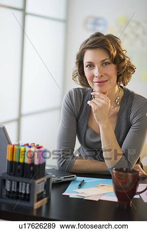 Portrait of smiling woman in home office View Large Photo Image Stock Photo - Portrait of smiling woman in home office. Fotosearch