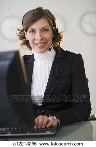 Portrait of smiling woman with headset in customer service office View Large Photo Image Stock Photograph - Portrait of smiling woman with headset in customer service office. Fotosearch