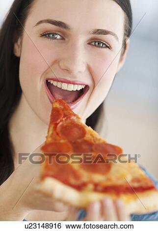 Portrait of smiling young woman eating pizza View Large Photo Image Stock Photograph - Portrait of smiling young woman eating pizza. Fotosearch