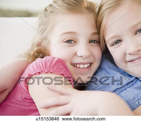 Stock Photograph - Portrait of two sisters (8-11). Fotosearch
