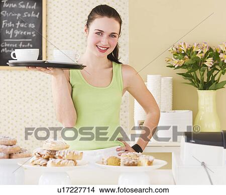 Portrait of waitress holding tray View Large Photo Image Picture - Portrait of waitress holding tray. Fotosearch