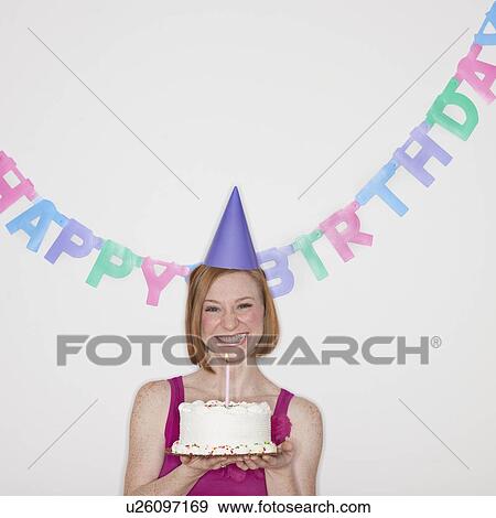 Stock Photo - Portrait of woman celebrating birthday. Fotosearch