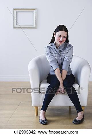 Portrait of woman sitting in armchair View Large Photo Image Stock Image - Portrait of woman sitting in armchair. Fotosearch