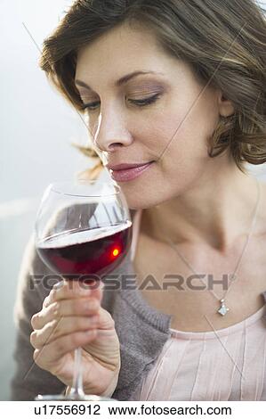 Portrait of woman smelling red wine View Large Photo Image Stock Image - Portrait of woman smelling red wine. Fotosearch