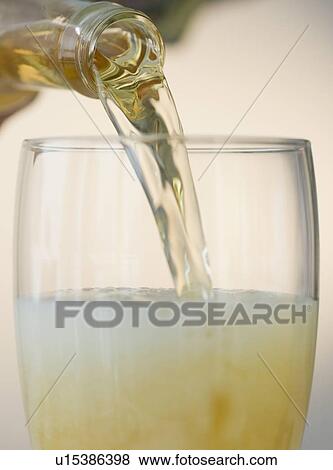 Stock Photo - Pouring beer into pint glass. Fotosearch
