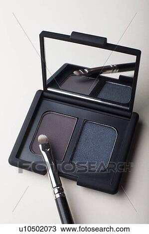 Stock Image - Powder compact with small brush. Fotosearch