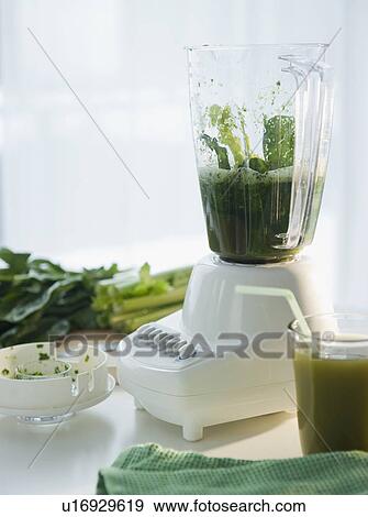 Stock Photo - Preparation of spinach juice in blender. Fotosearch
