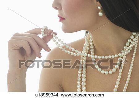 Picture - Profile of young woman wearing pearls. Fotosearch