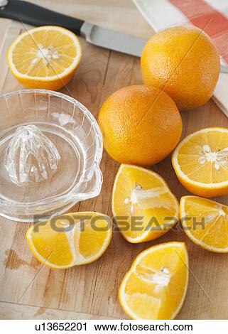 Stock Image - Sliced oranges on chopping board. Fotosearch