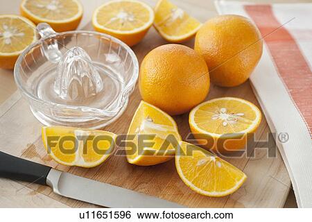 Sliced oranges on chopping board View Large Photo Image Stock Photograph - Sliced oranges on chopping board. Fotosearch