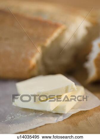 Stock Photography - Slices of butter and fresh breadClose-up. Fotosearch