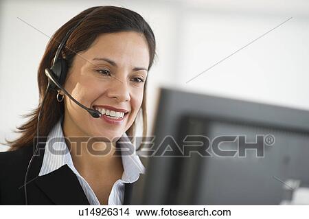 Picture - Smiling female customer service representative with headset. Fotosearch