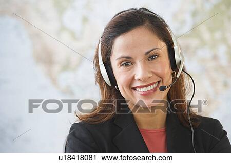 Stock Image - Smiling female customer service representative with headset . Fotosearch