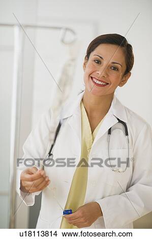 Picture - Smiling female doctor with IV drip. Fotosearch
