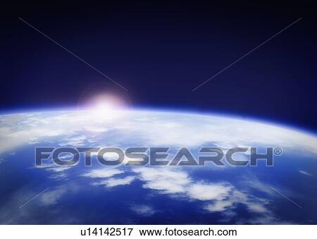 Stock Photo - Space with rising sun above planet earth. Fotosearch