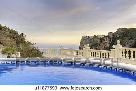 Stock Photo - Spain, Costa Blanca, Hotel swimming pool. Fotosearch