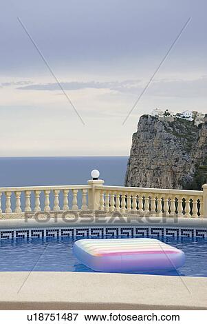 Spain, Costa Blanca, Swimming pool on terrace, sea and cliff in background View Large Photo Image Stock Photo - Spain, Costa Blanca, Swimming pool on terrace, sea and cliff in background. Fotosearch