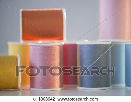 Stock Image - Spools with colorful threads. Fotosearch