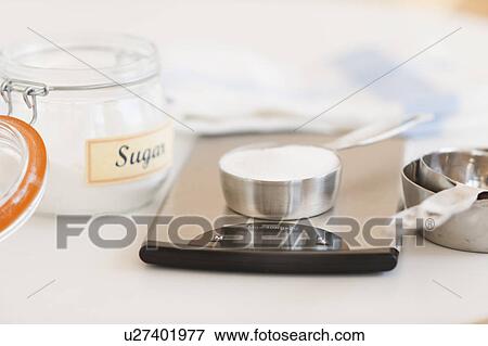 Spoon of sugar on weight scale View Large Photo Image Stock Photo - Spoon of sugar on weight scale. Fotosearch
