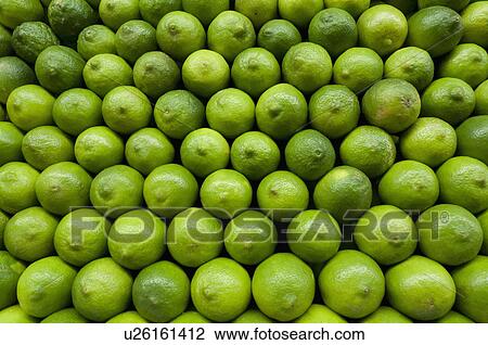 Stock Image - Stack of limes on market. Fotosearch