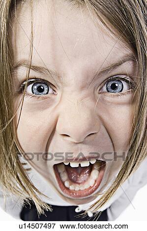 Stock Photo - Studio portrait of girl (6-7) screaming. Fotosearch